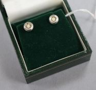 A small pair of 18ct white gold and diamond earstuds.
