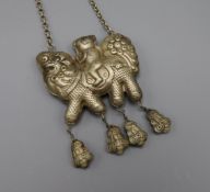 A Chinese white metal pendant on chain