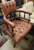 A modern mahogany and buttoned leather desk chair