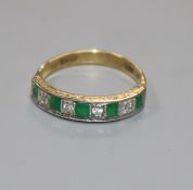 A modern 18ct gold, emerald and diamond nine stone half hoop ring, size N.
