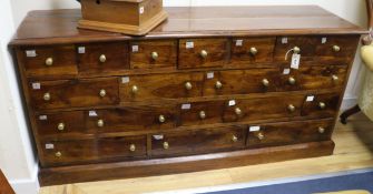 A shop counter of nineteen drawers W.162cm