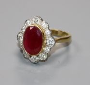 A modern 18ct gold, ruby and diamond oval cluster ring, size N.