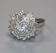 An 18ct white gold and diamond cluster ring, the central stone weighing approximately 0.90cts,