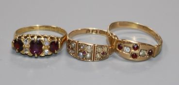 Two early 20th century 15ct gold and gem set rings and a similar 18ct gold and gem set ring.