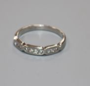 A modern 18ct white gold and seven stone diamond half hoop ring, size N/O.