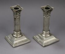 A pair of late Victorian silver corinthian column dwarf candlesticks (no sconces), Sheffield,