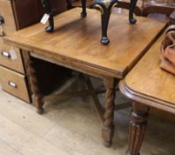 A 1920's oak drawleaf table