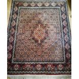 A Persian red ground rug 150 x 123cm