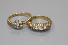 Two 18ct gold and diamond dress rings (one stone missing).