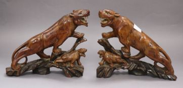 A pair of Chinese hardwood figures of tigers tallest 18cm