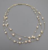 A modern 14ct and cultured pearl triple strand necklace, approx. 34cm.