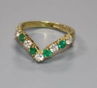 A modern 18ct gold, emerald and diamond wishbone ring, size O.