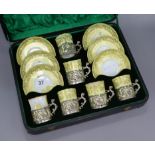 A cased yellow ground porcelain and silver mounted coffee set