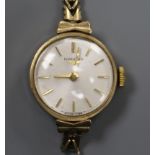 A lady's 9ct gold Longines manual wind wrist watch, on a 9ct gold bracelet (af).