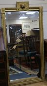 A gilt framed mirror with lion mask top W.74.5cm