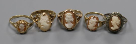 Four assorted 9ct gold and oval cameo set dress rings and a white metal and cameo ring.