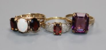 Three assorted 9ct gold and gem set dress rings,.