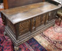 A Spanish walnut coffer, 18th century, enclosed by a hinged top with carved interior over a carved