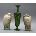 A Bohemian green and gilt glass vase, and a pair of ceramic wall pockets in the form of herons