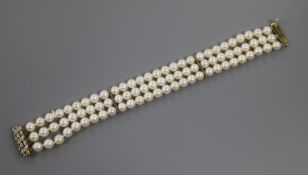 A three-row cultured pearl bracelet with 15ct gold and diamond spiral-decorated openwork clasp.