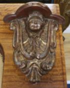 A pair of gilt carved wood mask brackets length 29cm
