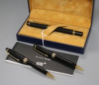 A Montblanc Meisterstuck black and gold ballpoint/propelling pencil set and a Waterman fountain