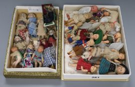 A collection of twenty six miniature dolls, a doll's pram and sheep