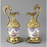 A pair of Chinese export porcelain and French ormolu mounted ewers, each body formed form a Qianlong