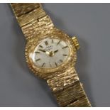 A lady's textured 9ct gold Rotary manual wind wrist watch.
