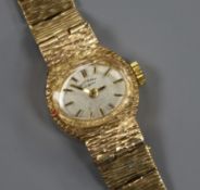 A lady's textured 9ct gold Rotary manual wind wrist watch.