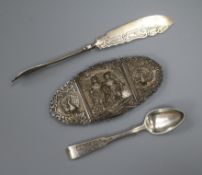 An Indian white metal belt buckle, a 19th century Russian silver teaspoon and a continental butter