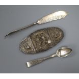 An Indian white metal belt buckle, a 19th century Russian silver teaspoon and a continental butter