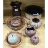 A collection of Brazilian incised terracotta and carved wood bowls and vases diameter 29cm