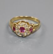 A small early 20th century ruby and rose cut diamond set cluster ring, size G.