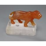 A Chinese chalcedony figure of a tiger with a rock crystal, on stand width 9.5cm