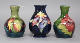 Three Moorcroft small vases in leaf and berry, hibiscus and orchid patterns tallest 9cm