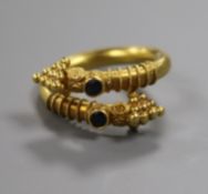 A yellow metal and gem set Etruscan style ring, size I.