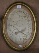 A Regency oval silk embroidered panel worked with a bird amongst branches and a drawing of "