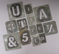 A collection of tin stencil letters and numbers for sacks etc