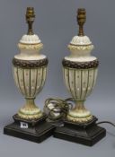 A pair of cream and green urn shaped table lamps