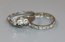 An 18ct gold ,platinum and three stone diamond crossover ring and a white metal and diamond full