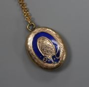 An early 20th century yellow metal and enamel oval locket with glazed back, on a later 9ct gold