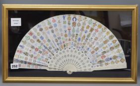 A framed ivory fan decorated with letter crests fan width 45cm height 23cm