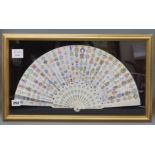 A framed ivory fan decorated with letter crests fan width 45cm height 23cm