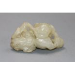 A 19th century Chinese pale celadon jade lion-dog and cub carving