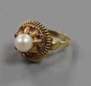 A yellow metal, cultured pearl and ruby set cocktail ring, size N.