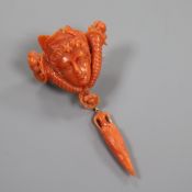 A 19th century yellow metal mounted carved coral drop brooch, modelled as the head of a lady between