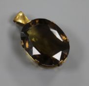 A 9ct gold mounted facet cut smoky quartz pendant, 42mm.