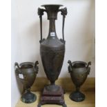 A large bronzed spelter urn and a pair of similar smaller urns tallest 70cm
