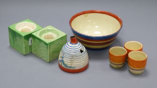 A Clarice Cliff Pine Grove honey jar, an abstract bowl, three egg cups and a pair of cube